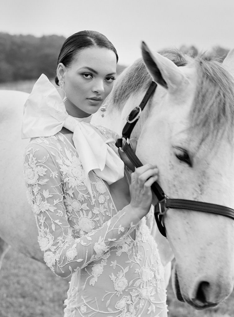 Fine art inspired wedding inspiration featuring a moody editorial photography shot with a horse