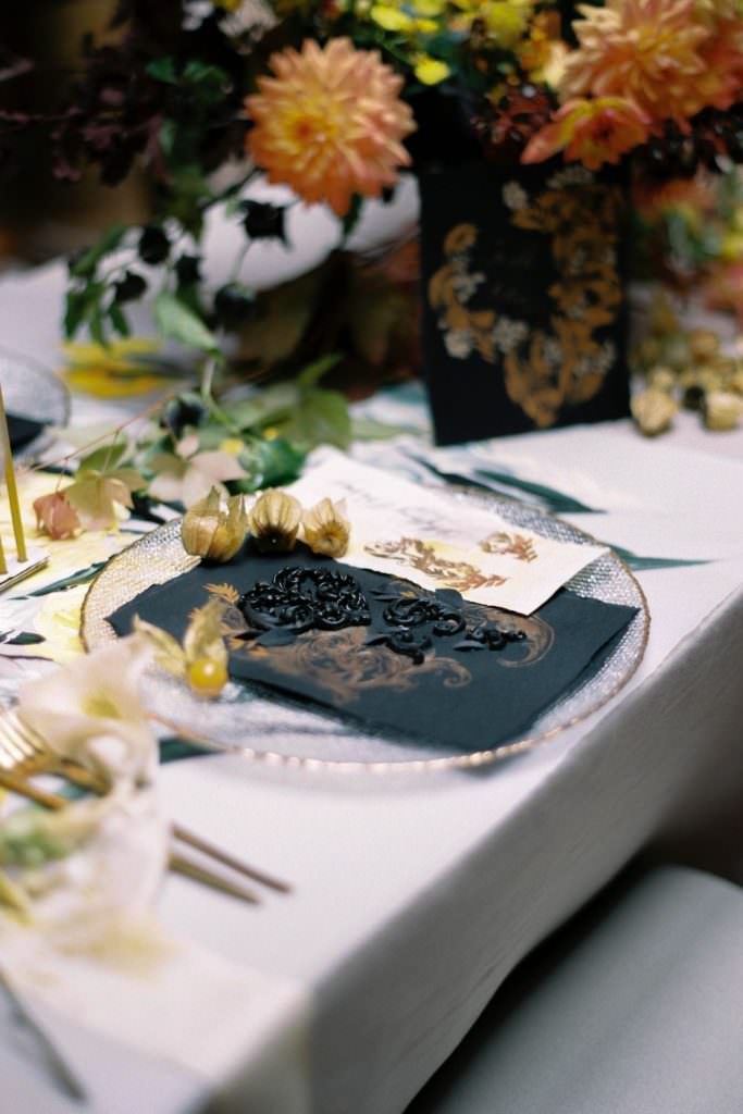 High-end, fashion wedding inspiration with a colourful hand painted table design with black and gold, luxury-chic wedding invitations