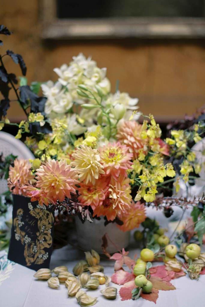 Beautiful and elegant country wedding inspiration with a moody rich coral and yellow floral centre piece