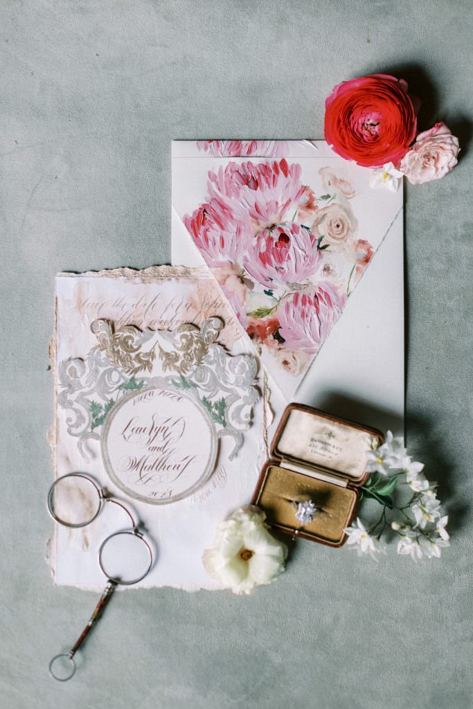 Italian inspired invitations inspired by the interiors of Villa Pizzo, featuring an ornate silver and gold crest design save the date card