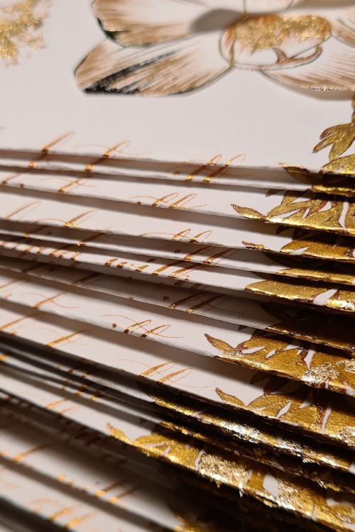 Hand crafted gold wedding menu close up detail