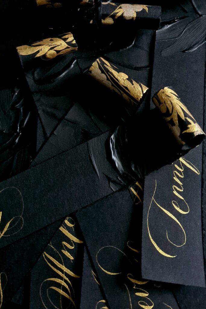 Luxury black tie, modern romantic, Italian style place names with gold calligraphy and rich black on black paint artwork