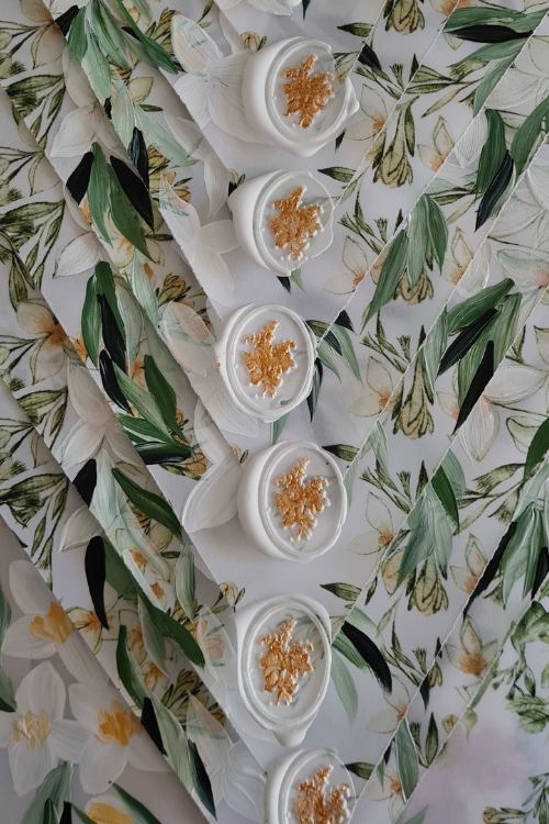 Romantic Amalfi Style white floral envelopes on velum with a white and gold wax seal design