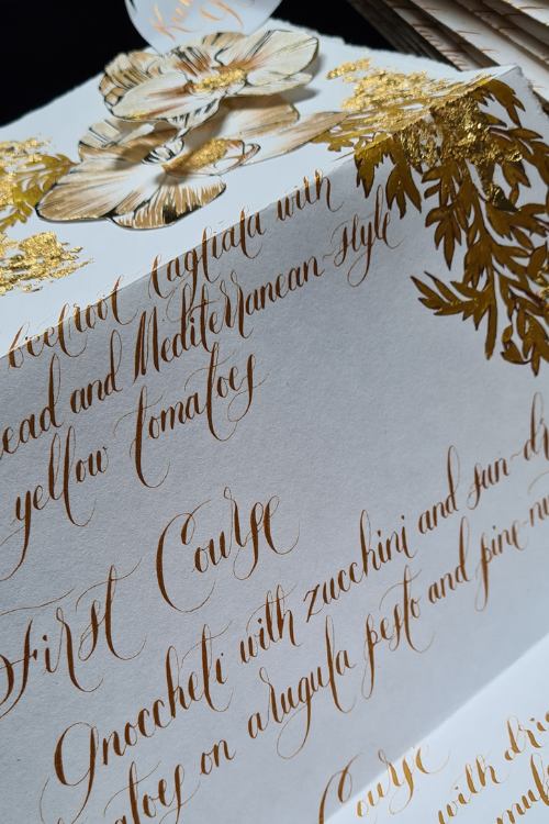 Sophisticated and luxurious, handwritten gold calligraphy Orchid wedding menu design for an Italian wedding